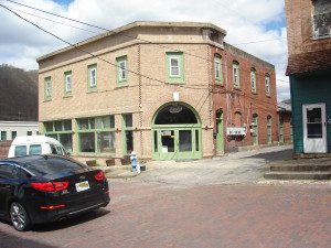 A car parked in front of a brick building.